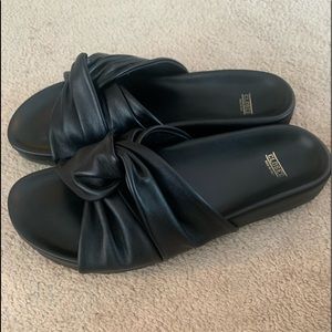 Black leather slides by german retail brand Closed, known for its high end jeans